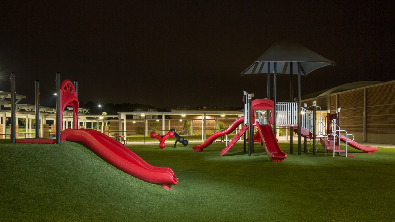 Nighttime artificial turf playground by Southwest Greens of Austin